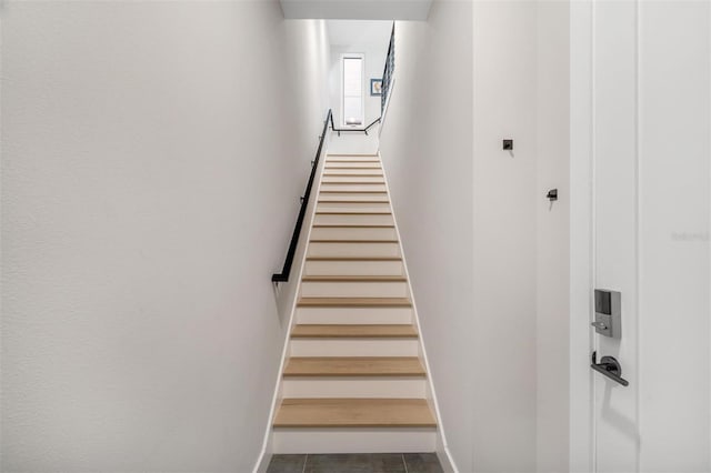 stairs featuring tile patterned floors