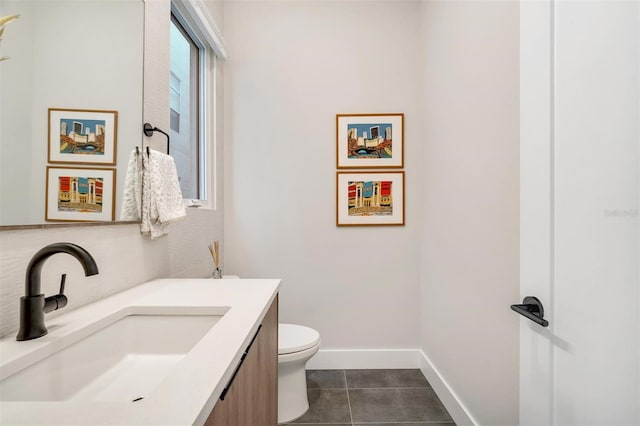 bathroom featuring tile patterned flooring, vanity, and toilet