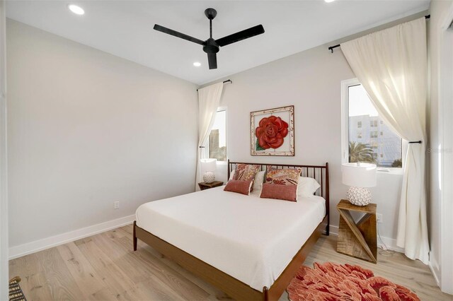 bedroom with ceiling fan and light wood-type flooring