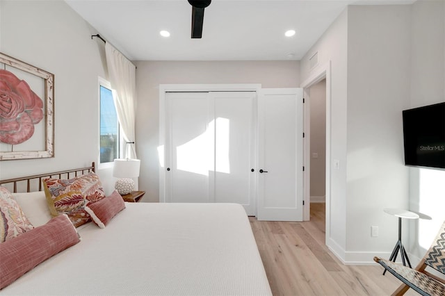 bedroom featuring light hardwood / wood-style flooring and ceiling fan