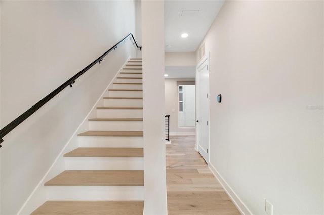 stairs with hardwood / wood-style flooring