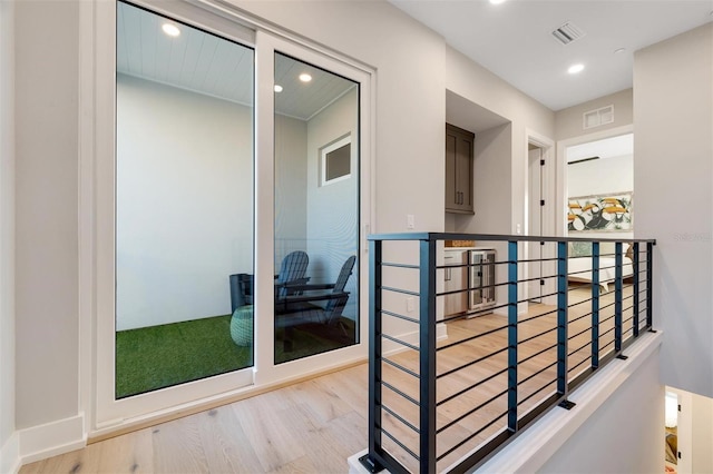 hall with light hardwood / wood-style floors