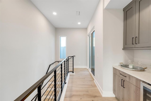 hallway with light wood-type flooring and wine cooler