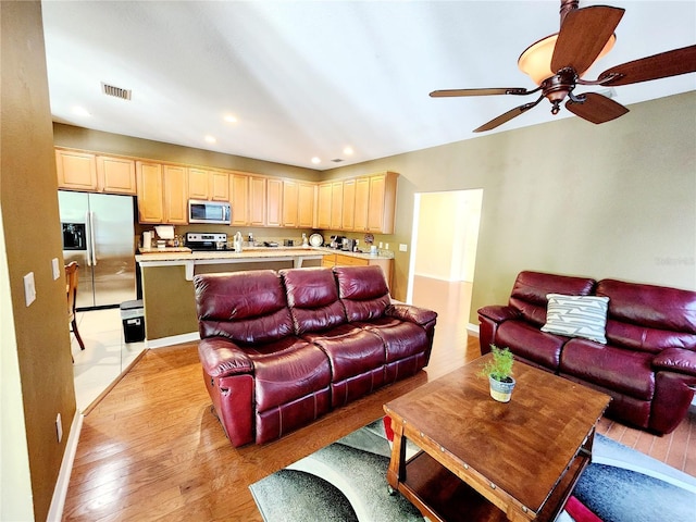 living room with ceiling fan and light wood-type flooring