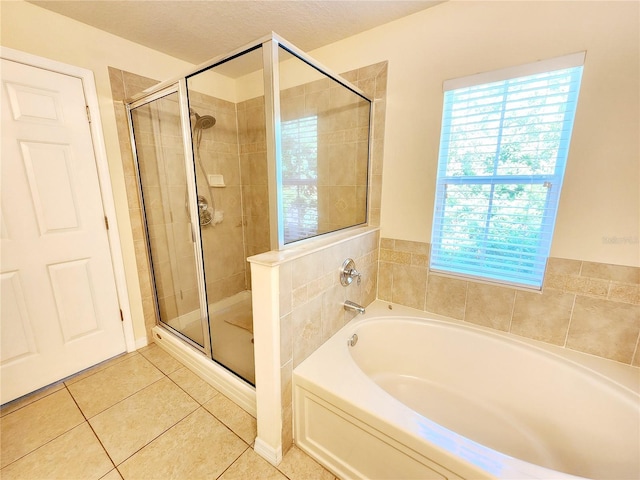 bathroom featuring tile patterned floors, plus walk in shower, and a textured ceiling