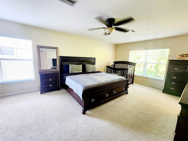 bedroom with light colored carpet and ceiling fan