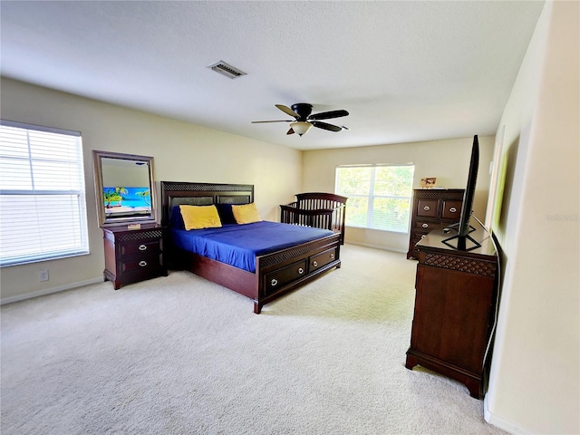 bedroom featuring ceiling fan and light colored carpet