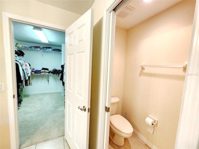 bathroom featuring tile patterned flooring and toilet