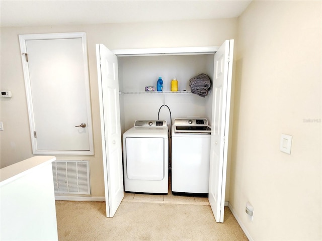 laundry area with light carpet and washer and clothes dryer