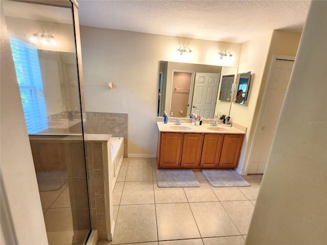 bathroom featuring vanity, tile patterned floors, plus walk in shower, and a textured ceiling