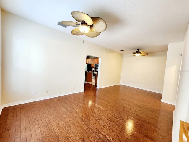 unfurnished living room featuring hardwood / wood-style flooring and ceiling fan