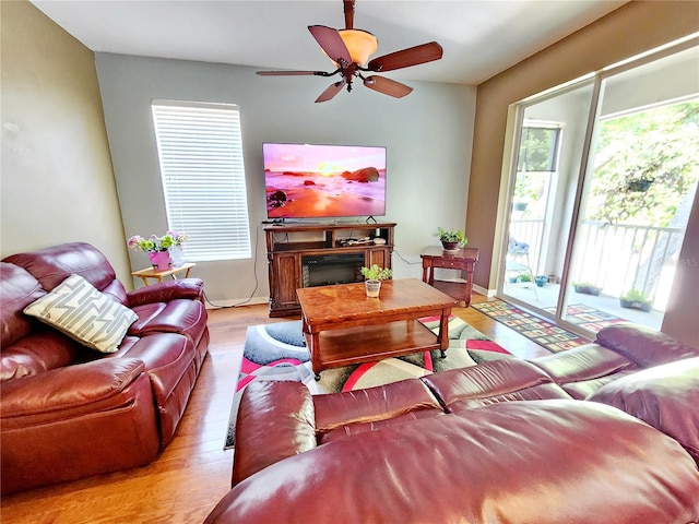 living room featuring light hardwood / wood-style floors and ceiling fan