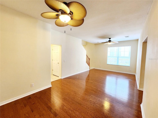 empty room with a textured ceiling, light hardwood / wood-style floors, and ceiling fan