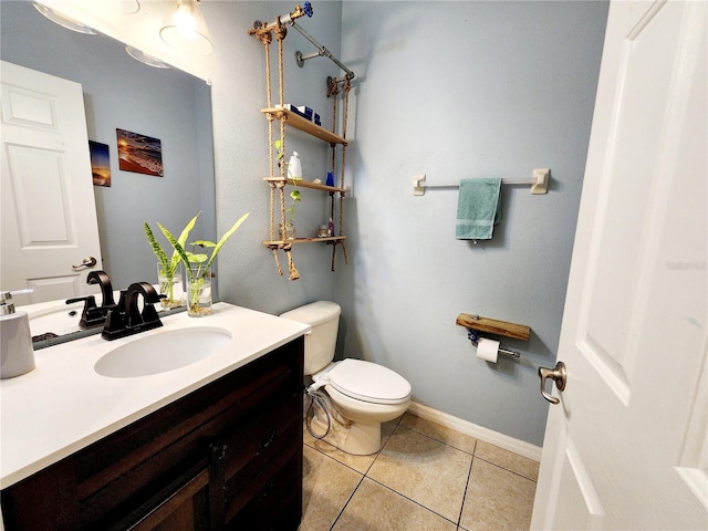 bathroom featuring vanity, tile patterned floors, and toilet