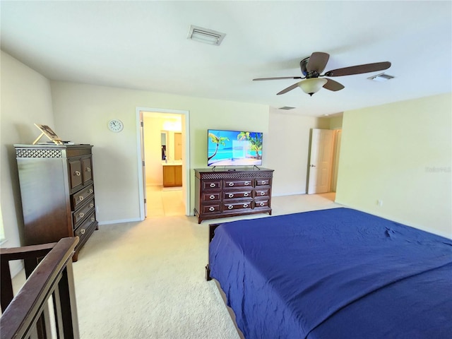 bedroom featuring light carpet, connected bathroom, and ceiling fan