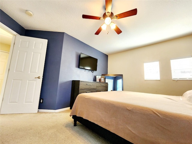 bedroom featuring lofted ceiling, light colored carpet, and ceiling fan