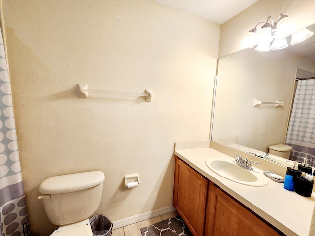 bathroom with vanity, tile patterned floors, and toilet