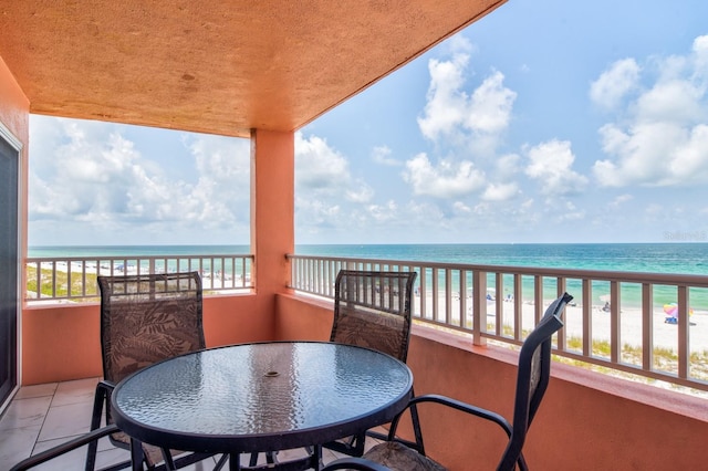 balcony with a water view and a beach view