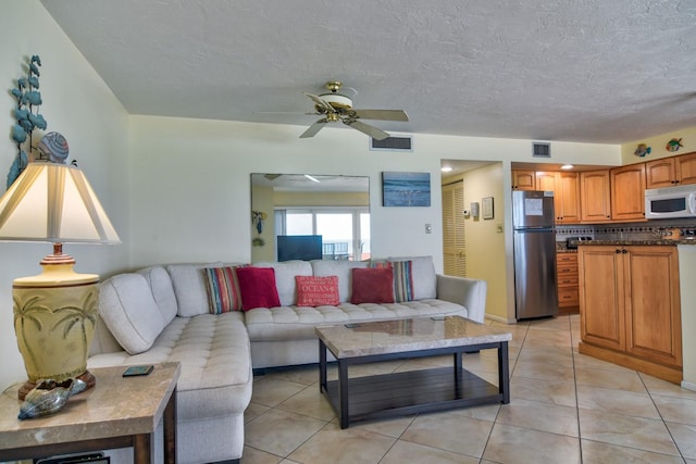 living room featuring ceiling fan and light tile patterned floors