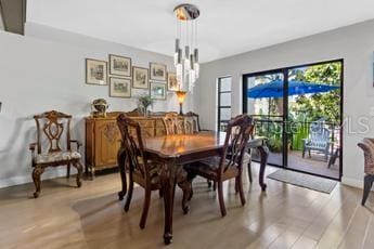 dining room featuring light hardwood / wood-style floors and an inviting chandelier