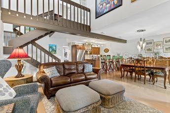 living room featuring a notable chandelier and a towering ceiling