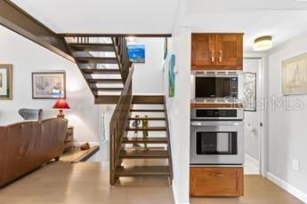 stairs featuring light hardwood / wood-style flooring