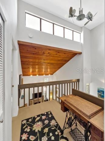 interior space with high vaulted ceiling, wood ceiling, and a chandelier