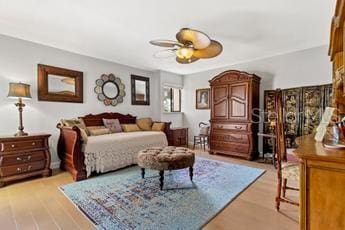 bedroom with ceiling fan and hardwood / wood-style flooring