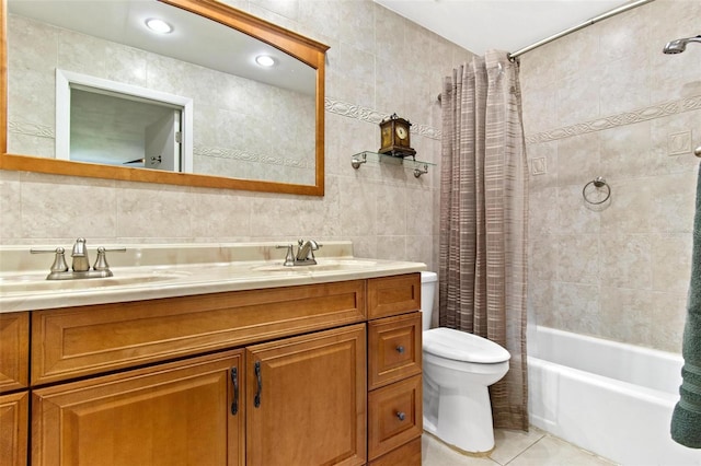 full bathroom with tile floors, shower / tub combo with curtain, tile walls, dual vanity, and toilet