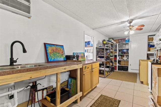 kitchen with a textured ceiling, ceiling fan, and light tile flooring