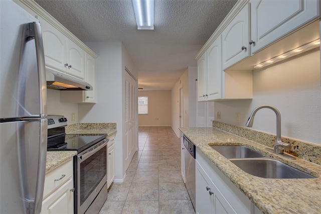 kitchen with light tile floors, white cabinets, sink, a textured ceiling, and appliances with stainless steel finishes