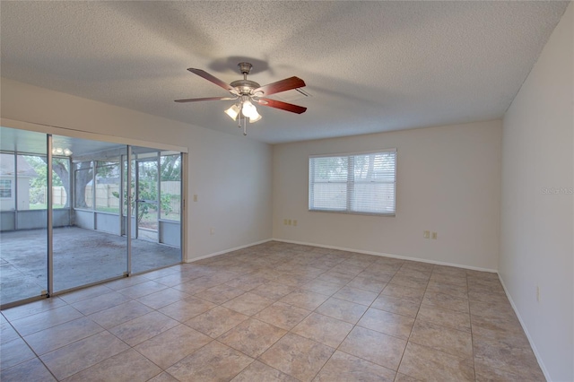 tiled spare room with ceiling fan and a textured ceiling