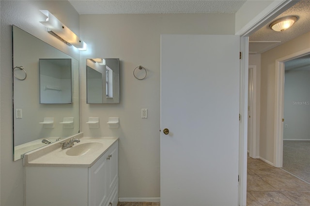 bathroom with tile floors, a textured ceiling, and oversized vanity