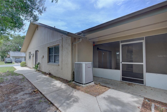 view of side of home featuring central AC unit