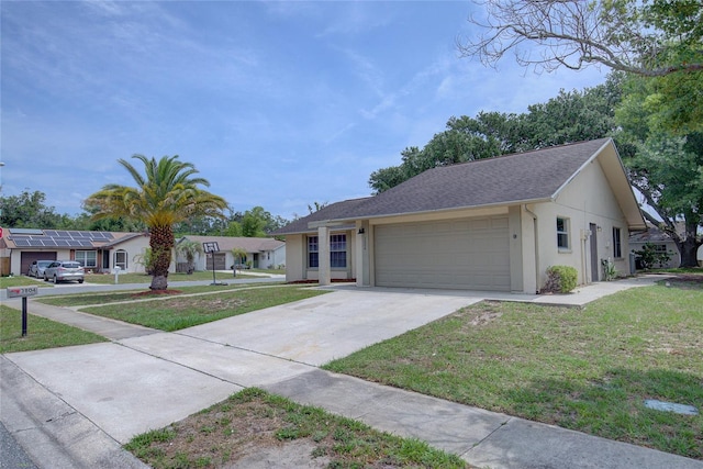 ranch-style home with a front yard, a garage, and solar panels