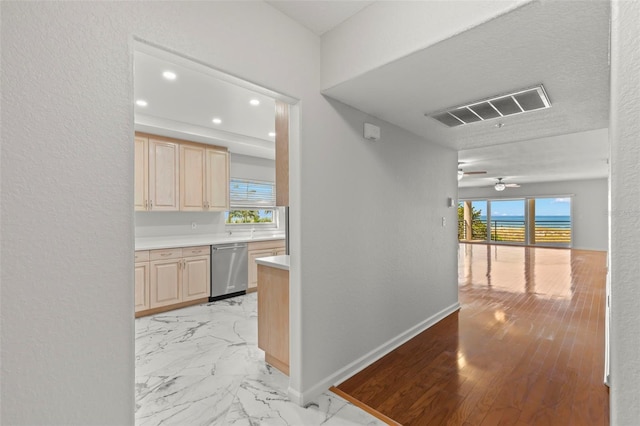 corridor with plenty of natural light and light tile flooring