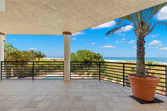 view of patio / terrace featuring a balcony and a water view