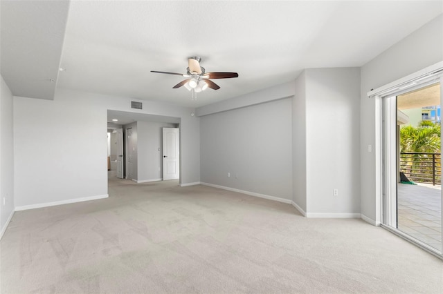 carpeted spare room featuring ceiling fan