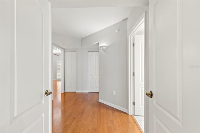 hallway with light hardwood / wood-style flooring