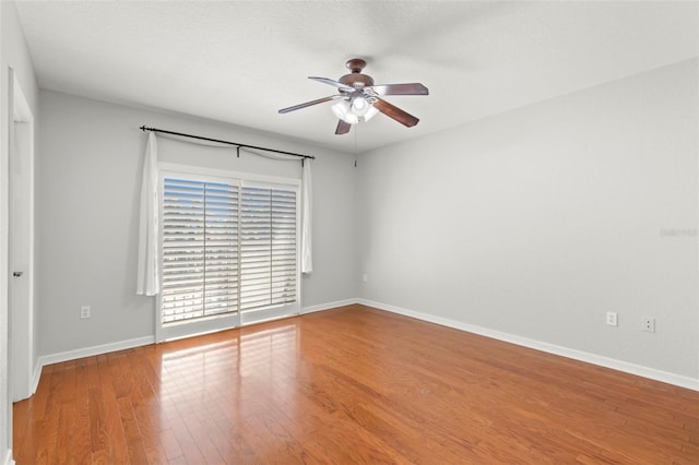 spare room featuring hardwood / wood-style flooring and ceiling fan