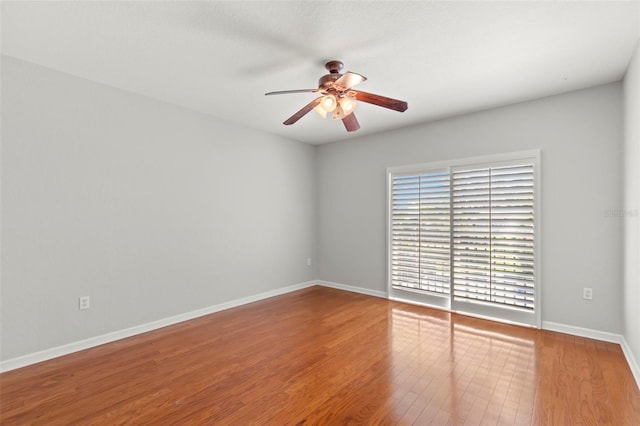 spare room with hardwood / wood-style flooring and ceiling fan