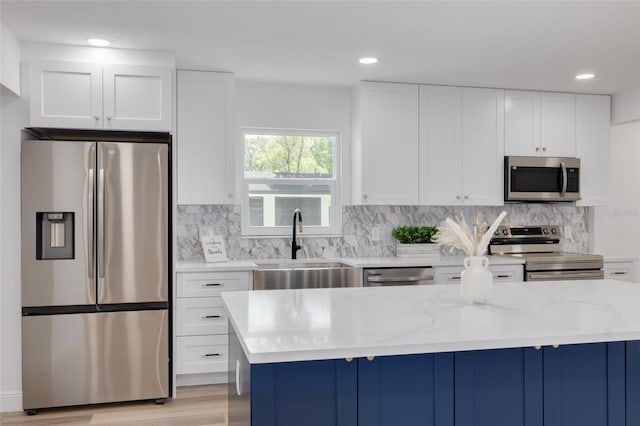 kitchen featuring light stone counters, white cabinets, and appliances with stainless steel finishes