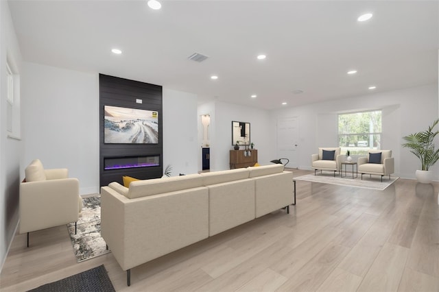 living room with a fireplace and light hardwood / wood-style floors