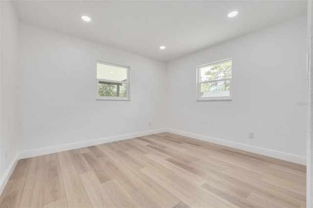 unfurnished room featuring light hardwood / wood-style flooring and plenty of natural light