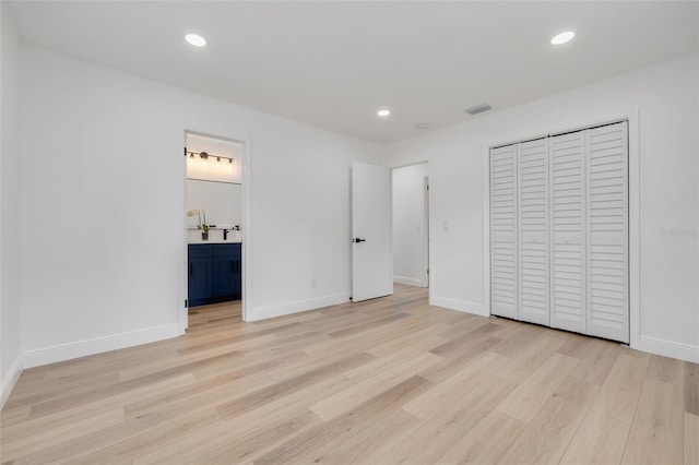 7414 Van Dyke Rd, Odessa, FL 33556 - unfurnished bedroom featuring light wood-style floors, baseboards, recessed lighting, a closet, and ensuite bathroom