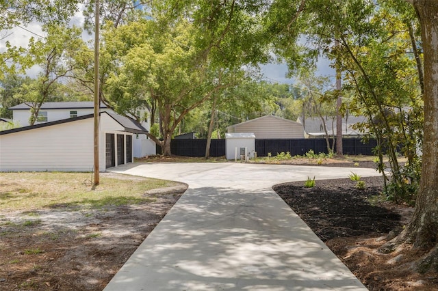 7414 Van Dyke Rd, Odessa, FL 33556 - view of yard featuring fence, driveway, and an outdoor structure