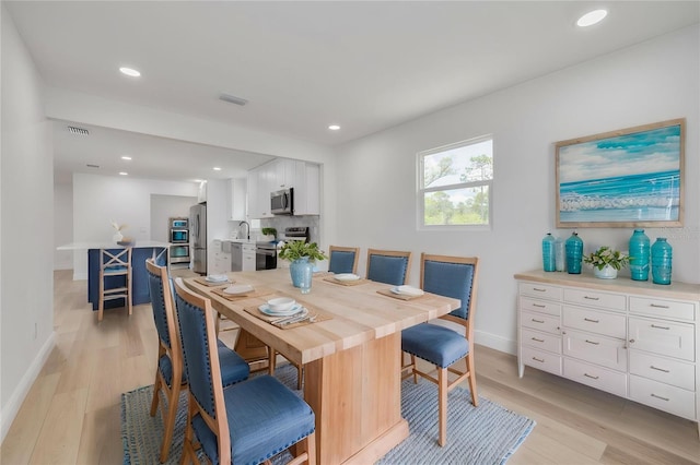 7414 Van Dyke Rd, Odessa, FL 33556 - dining room with light wood finished floors, baseboards, and recessed lighting