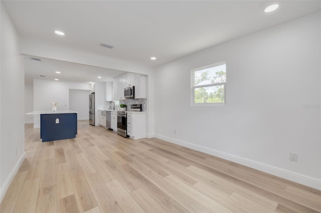 7414 Van Dyke Rd, Odessa, FL 33556 - unfurnished living room featuring light wood finished floors, baseboards, and recessed lighting