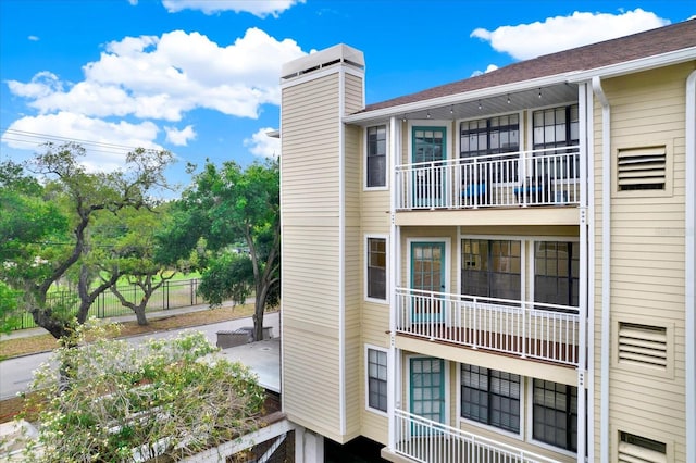 view of side of home with a balcony