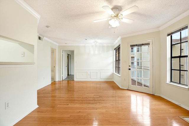 empty room featuring crown molding, a textured ceiling, ceiling fan, and light hardwood / wood-style flooring